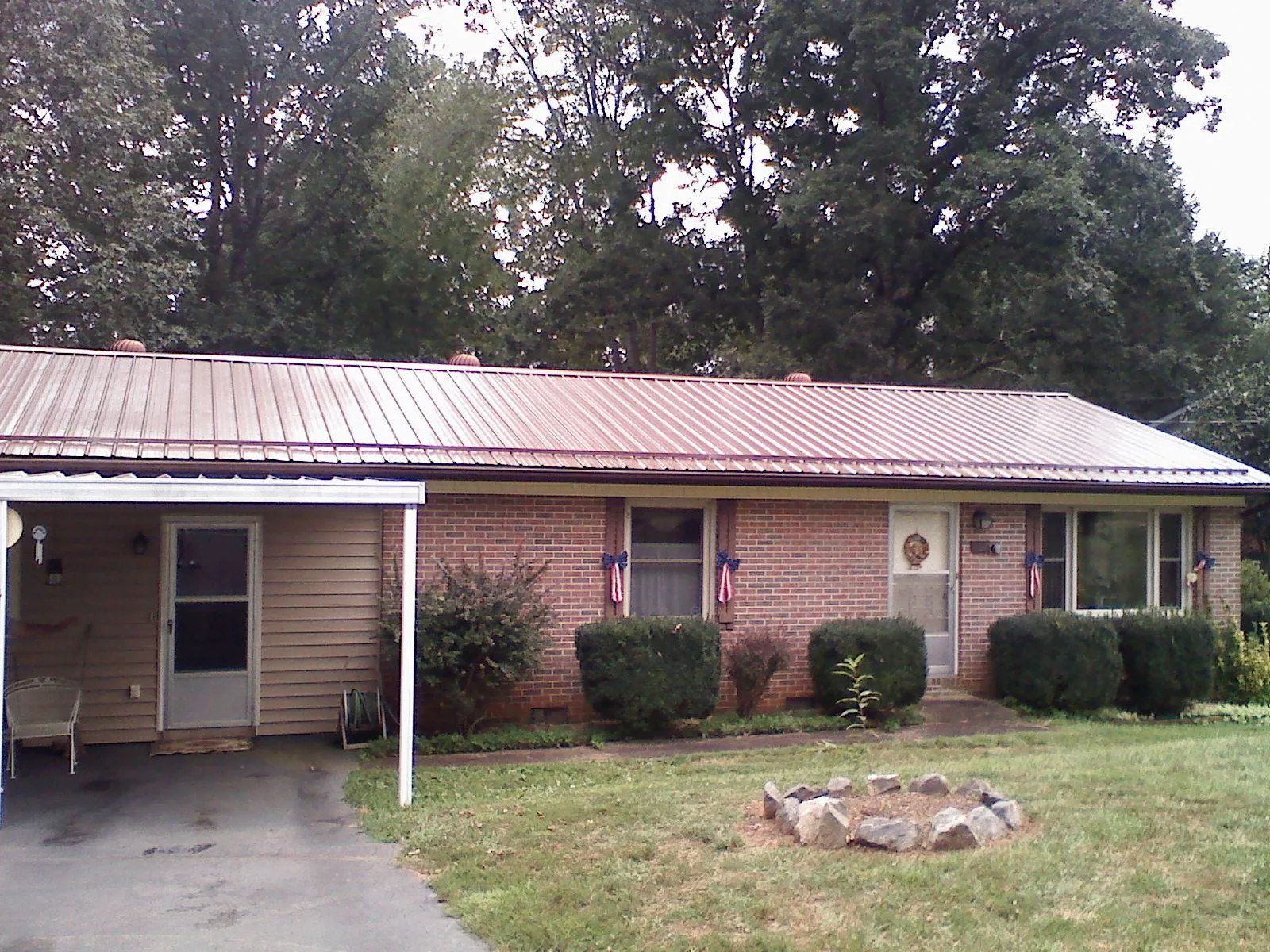Bronze metal roof and carport on a brick ranch home — Roof Repair work by our crew in West Grove